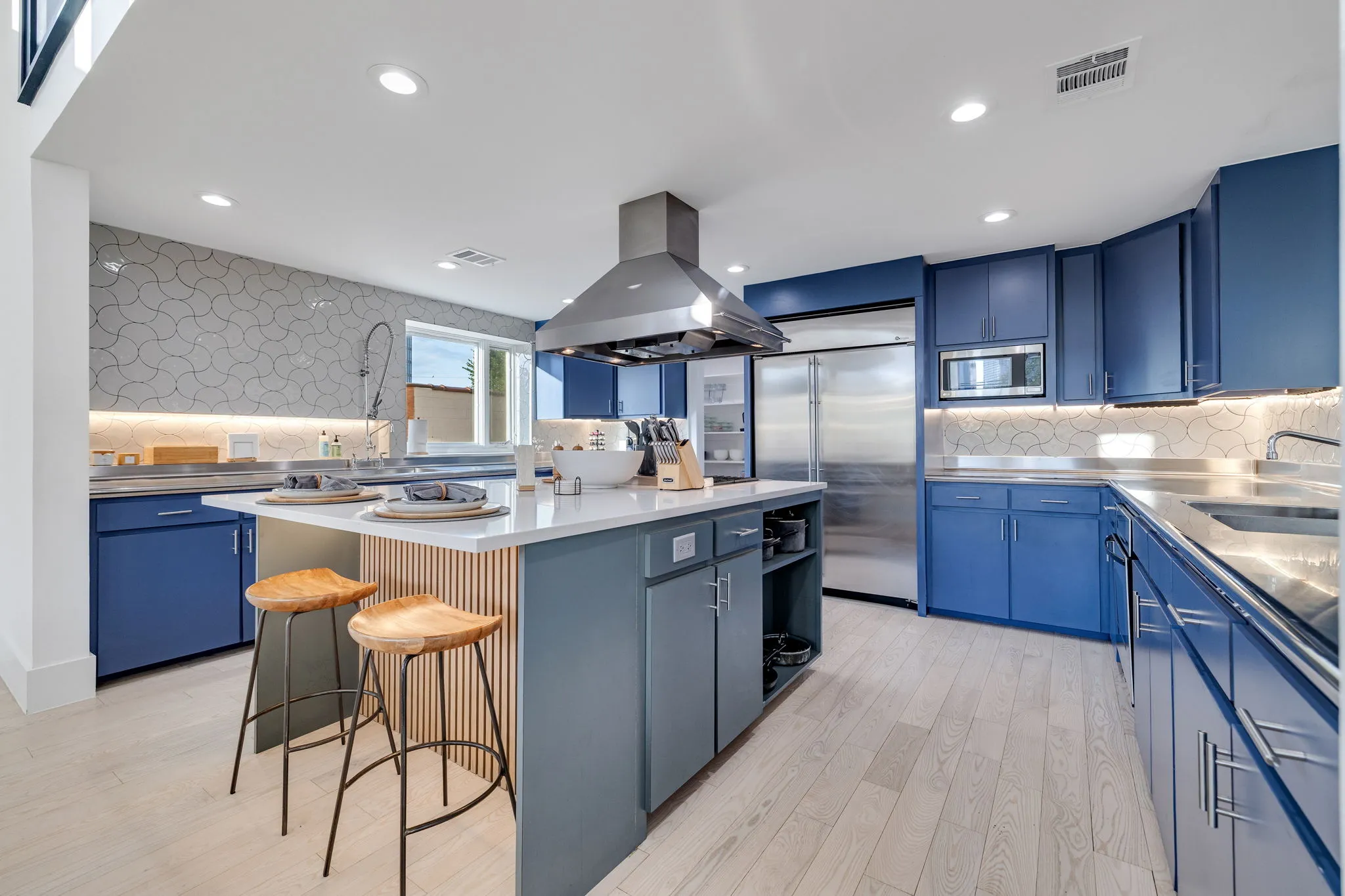 Ellum House open kitchen with island seating and dining table for 12