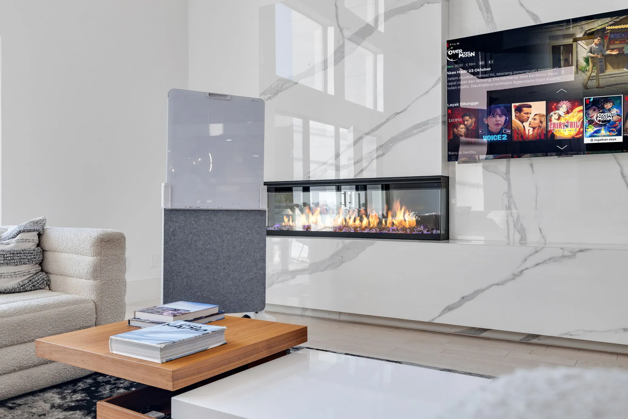 Second floor living area with fireplace and media setup at Ellum House