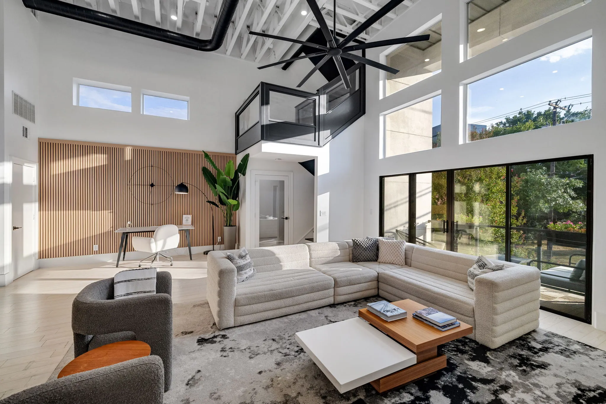 Bright open loft living area with high ceilings at Ellum House